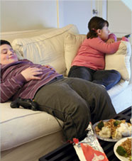 Fat children on a sofa